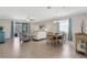Open concept living room featuring tile floors, ceiling fan, sliding glass doors, and bright décor at 19340 Bluff Dr, Venice, FL 34292