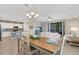 Open-concept living room, dining area and kitchen with white cabinets and sliding glass doors at 19340 Bluff Dr, Venice, FL 34292