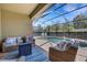 Relaxing outdoor patio area with wicker furniture and scenic pool views, perfect for entertaining or unwinding at 19340 Bluff Dr, Venice, FL 34292