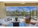 Screened-in patio featuring comfortable seating around a table, with a view of the pool and lush greenery at 19340 Bluff Dr, Venice, FL 34292