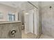 Walk in shower with a glass enclosure and neutral tiled walls at 19340 Bluff Dr, Venice, FL 34292