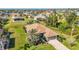 Wide aerial perspective of the property, showing the home, pool, and green spaces in the surrounding community at 205 Antis Dr, Rotonda West, FL 33947