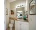 Cozy half bath with marble countertops and neutral decor at 205 Antis Dr, Rotonda West, FL 33947