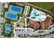 Aerial view of tennis and sports courts alongside a refreshing community pool and clubhouse, perfect for outdoor activities at 20740 Ovid Ln, Venice, FL 34293