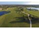 Stunning aerial view of the golf course, showcasing the community's scenic layout with lakes and walking paths at 217 Savona Way, North Venice, FL 34275