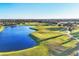 Aerial view showcasing the manicured golf course and adjacent water features at 217 Savona Way, North Venice, FL 34275