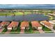 Aerial view of a charming neighborhood with homes surrounding a beautiful lake and golf course at 23415 Waverly Cir, Venice, FL 34293