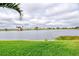Serene lake view from the well-maintained lawn, creating a peaceful and picturesque setting at 23415 Waverly Cir, Venice, FL 34293