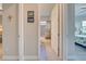 Hallway with bathroom view showing tile floors, vanity, and shower/tub combo with tropical shower curtain at 23415 Waverly Cir, Venice, FL 34293