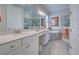 Bright bathroom with a double vanity, soaking tub, and tiled walk-in shower at 23415 Waverly Cir, Venice, FL 34293