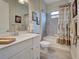 Clean bathroom with gray tile, modern vanity and decorative shower curtain adds a touch of style at 23415 Waverly Cir, Venice, FL 34293