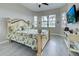 Bright bedroom with large windows, tile floor and TV offers a comfortable retreat at 23415 Waverly Cir, Venice, FL 34293