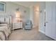 Charming bedroom with a wicker bed frame, tile floors, and beach-themed decor at 23415 Waverly Cir, Venice, FL 34293