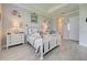 Comfortable bedroom with tile floor, white furniture and nautical decor radiates calm at 23415 Waverly Cir, Venice, FL 34293