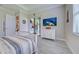 Bedroom with a white bed, wood-look tile floors, and slider to the lanai at 23415 Waverly Cir, Venice, FL 34293