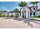 Welcoming clubhouse entrance featuring a covered walkway and manicured landscaping at 23415 Waverly Cir, Venice, FL 34293