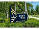 Elegant community sign surrounded by lush greenery, welcoming residents and visitors at 23415 Waverly Cir, Venice, FL 34293