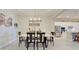 Open dining room leading into the kitchen area with stainless steel appliances at 23415 Waverly Cir, Venice, FL 34293
