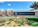 Stone sign at Sarasota National with cascading water features and manicured landscaping at the entrance at 23415 Waverly Cir, Venice, FL 34293