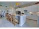 Spacious kitchen features white cabinetry, an island with seating, and modern appliances at 23415 Waverly Cir, Venice, FL 34293