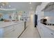 Bright kitchen features white cabinets, stainless steel appliances, and an island with bar seating at 23415 Waverly Cir, Venice, FL 34293