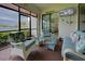 Screened lanai with seating area and views of the lake at 23415 Waverly Cir, Venice, FL 34293