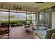 Screened lanai with seating area and views of the lake at 23415 Waverly Cir, Venice, FL 34293