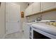 Functional laundry room with washer, dryer, storage cabinets, and countertop space at 23415 Waverly Cir, Venice, FL 34293