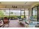 Screened-in patio with brick floors, comfortable seating and a view of the lake at 23415 Waverly Cir, Venice, FL 34293