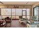 Screened-in patio with brick floors, comfortable seating and a view of the lake at 23415 Waverly Cir, Venice, FL 34293