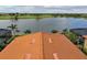 Rooftop view of a clay tile roof overlooking lake and golf course at 23415 Waverly Cir, Venice, FL 34293