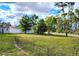 Large backyard with fencing and lush landscaping offers privacy and plenty of space for outdoor activities and enjoyment at 23495 Altman Ave, Punta Gorda, FL 33980