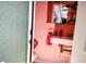 Charming powder room featuring a modern floating sink and unique flamingo decor at 23495 Altman Ave, Punta Gorda, FL 33980