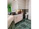 Neat bathroom with marble floors, a toilet, white cabinets, and a well-lit mirror at 23495 Altman Ave, Punta Gorda, FL 33980