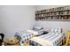 Charming bedroom with twin beds featuring blue gingham bedding and a collection of DVDs at 23495 Altman Ave, Punta Gorda, FL 33980