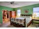 Inviting bedroom with green walls, rustic wooden furniture, and a cozy, relaxed atmosphere at 23495 Altman Ave, Punta Gorda, FL 33980