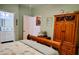 Relaxing bedroom showcasing wooden furniture, soft blue accents, and a glimpse into the Primary bath at 23495 Altman Ave, Punta Gorda, FL 33980