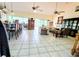 Open-concept living room and kitchen area, featuring tile flooring, ceiling fans, and sliding glass doors to the lanai at 23495 Altman Ave, Punta Gorda, FL 33980