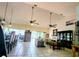 Open-concept living room boasts tile flooring, ceiling fans, and access to the lanai at 23495 Altman Ave, Punta Gorda, FL 33980