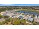 Stunning aerial view of a charming single-Gathering home in a well-planned community with lake and lush landscaping at 2572 Averland Loop, North Port, FL 34287
