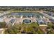 Aerial view of a backyard with an outdoor living area in a new neighborhood near a pond at 2572 Averland Loop, North Port, FL 34287