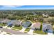A closer aerial view of a one-story home featuring a well manicured lawn and driveway at 2572 Averland Loop, North Port, FL 34287