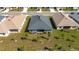 Aerial view of backyard with lawn, young trees, patio, and neighborhood homes at 2572 Averland Loop, North Port, FL 34287