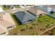 Aerial view of a house showing a well-manicured lawn and small trees at 2572 Averland Loop, North Port, FL 34287