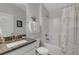 The bathroom features granite countertops, a white vanity, toilet, and shower-tub combination with tile and a curtain at 2572 Averland Loop, North Port, FL 34287