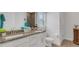Bright bathroom with double sinks, granite countertops, modern fixtures and a large well lit mirror at 2572 Averland Loop, North Port, FL 34287