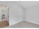 Empty bedroom with beige carpet and featuring an attached bathroom and double closet at 2572 Averland Loop, North Port, FL 34287