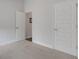 Bright bedroom features neutral carpet, white doors, and ample natural light at 2572 Averland Loop, North Port, FL 34287