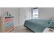 Bedroom features a full-size bed with a designer dresser and window, providing a relaxing retreat at 2572 Averland Loop, North Port, FL 34287