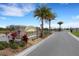 Community entrance sign for Watercress Cove with palm trees and a gated entrance at 2572 Averland Loop, North Port, FL 34287
